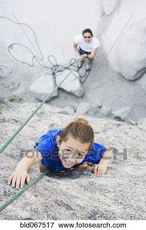 Asian mother and daughter rock climbing View Large Photo Image Stock Photo - Asian mother and daughter rock climbing. Fotosearch