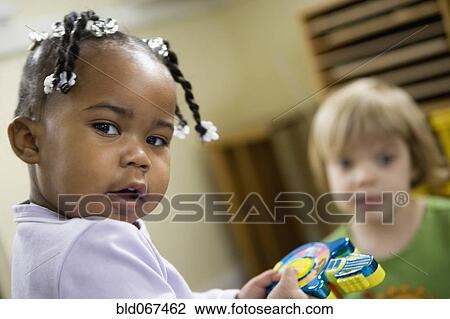 Stock Image - Children playing with toys. Fotosearch