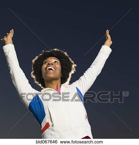 Confident African woman cheering View Large Photo Image Stock Photograph - Confident African woman cheering. Fotosearch
