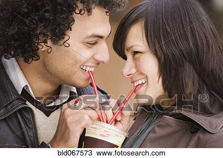 Couple drinking from one cup View Large Photo Image Stock Image - Couple drinking from one cup. Fotosearch