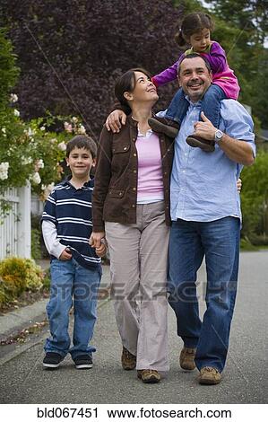 Family walking on residential street View Large Photo Image Stock Image - Family walking on residential street. Fotosearch