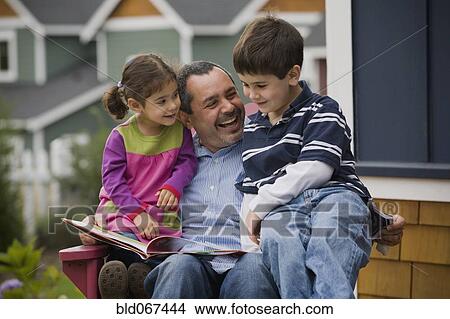 Picture - Father reading to son and daughter on porch. Fotosearch