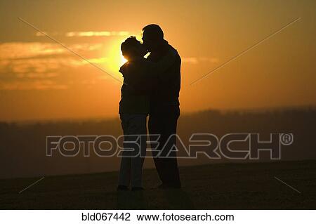 Hispanic couple kissing outdoors at sunset View Large Photo Image Stock Image - Hispanic couple kissing outdoors at sunset. Fotosearch