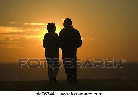 Hispanic couple standing outdoors at sunset View Large Photo Image Stock Image - Hispanic couple standing outdoors at sunset. Fotosearch
