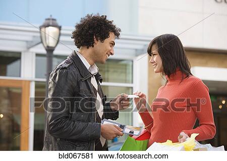 Middle Eastern man giving girlfriend credit card View Large Photo Image Stock Image - Middle Eastern man giving girlfriend credit card. Fotosearch