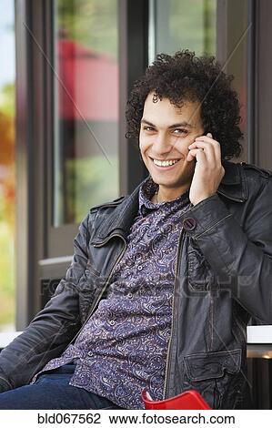 Middle Eastern man talking on cell phone View Large Photo Image Stock Image - Middle Eastern man talking on cell phone. Fotosearch