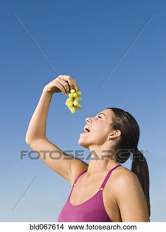 Picture - Native American eating grapes. Fotosearch