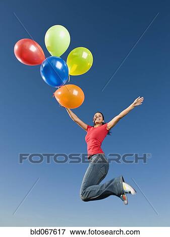 Native American holding balloons in mid-air View Large Photo Image Stock Photo - Native American holding balloons in mid-air. Fotosearch