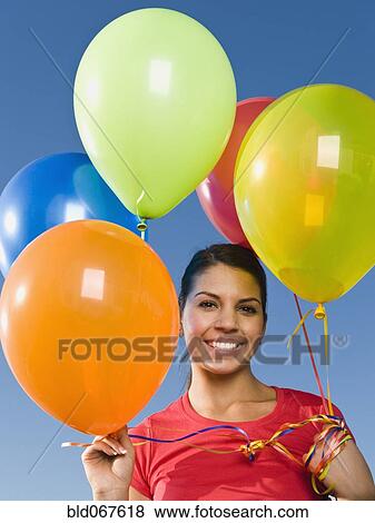 Stock Photo - Native American holding balloons. Fotosearch