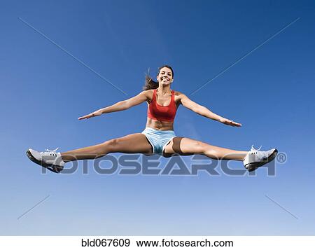 Stock Photo - Native American woman jumping in mid-air. Fotosearch