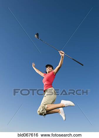 Native American woman with golf club jumping in mid-air View Large Photo Image Stock Photograph - Native American woman with golf club jumping in mid-air. Fotosearch