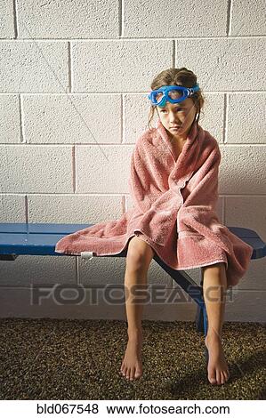 Stock Photo - Sad Asian girl in towel and goggles. Fotosearch