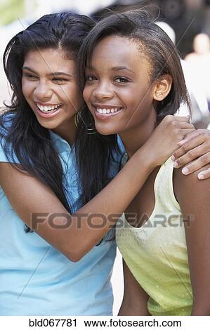 Teenage friends hugging View Large Photo Image Stock Image - Teenage friends hugging. Fotosearch