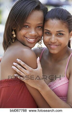 Stock Photo - Teenage friends hugging. Fotosearch