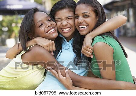 Stock Photography - Teenage friends hugging. Fotosearch