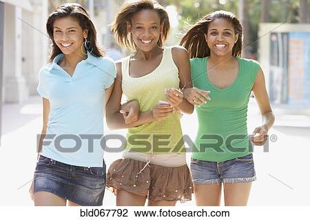 Stock Image - Teenage friends walking together. Fotosearch