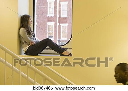 Stock Photography - Teenager sitting in window sill. Fotosearch