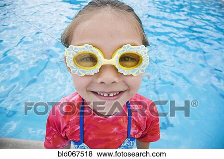 Stock Photo - Young Asian girl wearing fancy goggles. Fotosearch