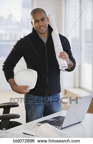 African American architect holding hard-hat and blueprints View Large Photo Image Stock Photograph - African American architect holding hard-hat and blueprints. Fotosearch