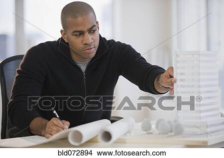 Picture - African American architect working on building model. Fotosearch