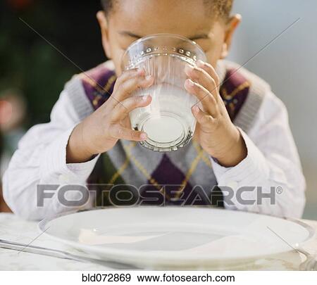 Stock Photo - African American boy drinking milk. Fotosearch