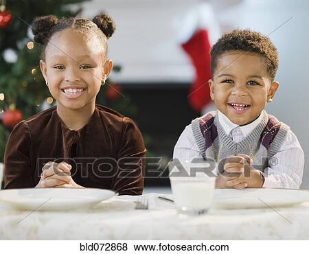 Stock Photo - African American brother and sister sitting at table. Fotosearch