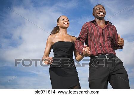 Picture - African American couple holding hands. Fotosearch