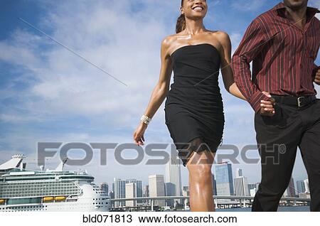 Stock Image - African American couple holding hands. Fotosearch