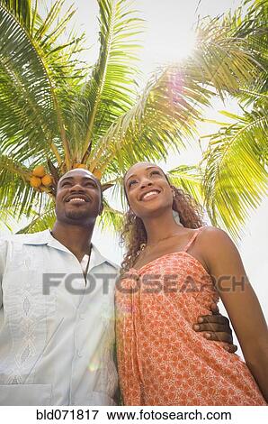 African American couple hugging under palm tree View Large Photo Image Stock Photo - African American couple hugging under palm tree. Fotosearch