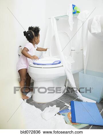 Stock Images Of African American Spreading Toilet Paper Around African American Spreading Toilet Paper Around Bathroom
