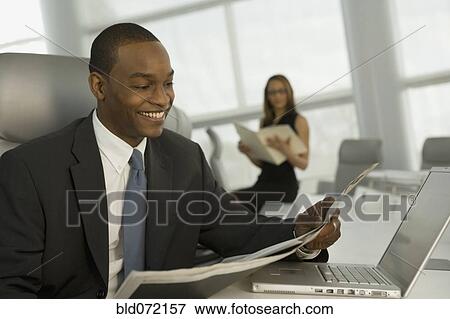 African business man reading newspaper View Large Photo Image Stock Photo - African business man reading newspaper. Fotosearch