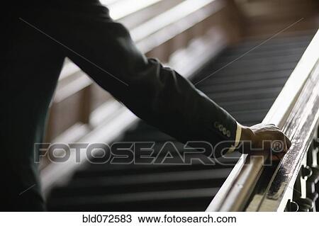 African businessman ascending staircase View Large Photo Image Stock Image - African businessman ascending staircase. Fotosearch