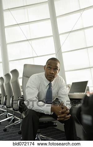 African businessman in conference room looking impatient View Large Photo Image Picture - African businessman in conference room looking impatient. Fotosearch