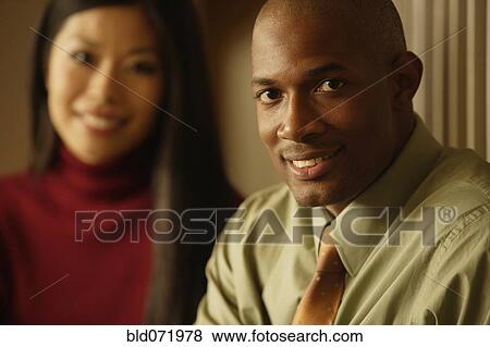 African businessman in front of Asian businesswoman View Large Photo Image Stock Photo - African businessman in front of Asian businesswoman. Fotosearch