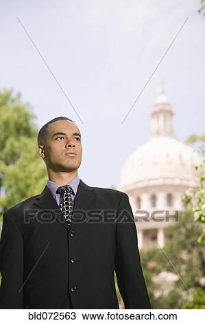 Stock Image - African businessman near capitol building. Fotosearch