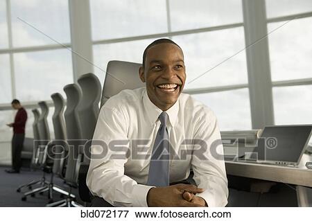 African businessman smiling in conference room View Large Photo Image Stock Photo - African businessman smiling in conference room. Fotosearch