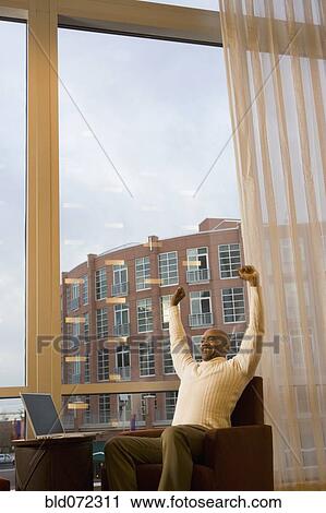Stock Image - African businessman stretching. Fotosearch