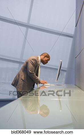 African businessman using computer View Large Photo Image Stock Photo - African businessman using computer. Fotosearch