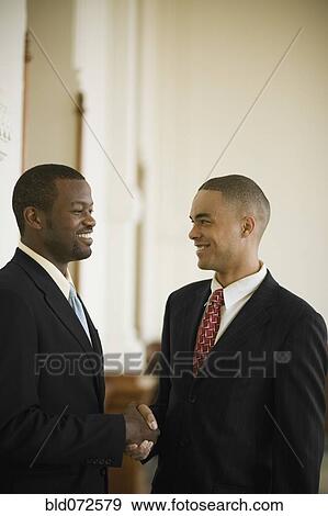 Stock Photo - African businessmen shaking hands. Fotosearch