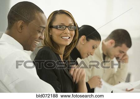 African businesswoman smiling in meeting View Large Photo Image Stock Photo - African businesswoman smiling in meeting. Fotosearch