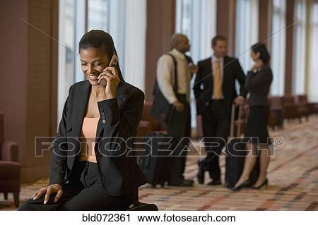 Stock Image - African businesswoman talking on cell phone. Fotosearch