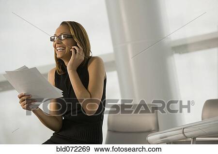 African businesswoman talking on cell phone in conference room View Large Photo Image Stock Photo - African businesswoman talking on cell phone in conference room. Fotosearch