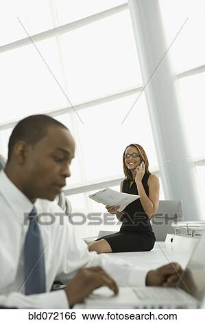 African businesswoman talking on cell phone in conference room View Large Photo Image Stock Photograph - African businesswoman talking on cell phone in conference room. Fotosearch