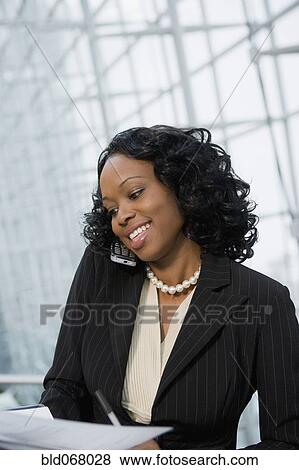 African businesswoman using cell phone View Large Photo Image Stock Photo - African businesswoman using cell phone. Fotosearch