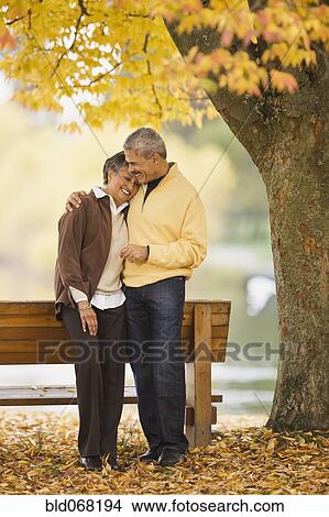 Picture - African couple hugging in autumn. Fotosearch