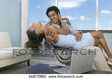 African couple hugging in chair View Large Photo Image Stock Photography - African couple hugging in chair. Fotosearch