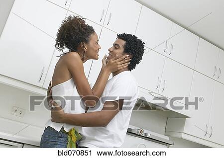 African couple hugging in kitchen View Large Photo Image Stock Image - African couple hugging in kitchen. Fotosearch