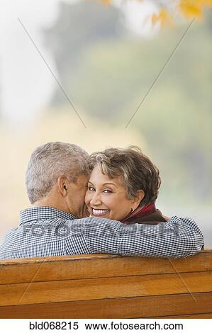 African couple hugging on park bench View Large Photo Image Stock Photography - African couple hugging on park bench. Fotosearch