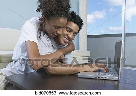 African couple looking at laptop View Large Photo Image Stock Image - African couple looking at laptop. Fotosearch