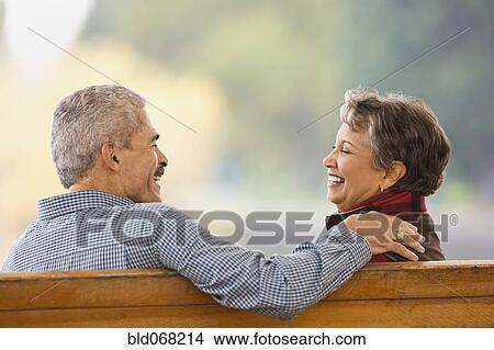 African couple sitting on bench View Large Photo Image Picture - African couple sitting on bench. Fotosearch